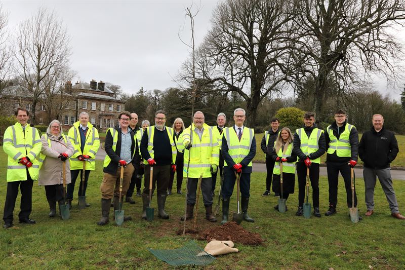 the whole group standing together in front of pelham house