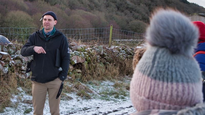 Lochlan talking to a group in a field