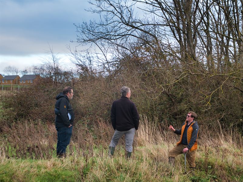 Gary talking to people in a field