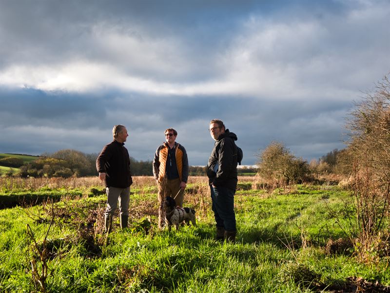 gary and team talking in a field 